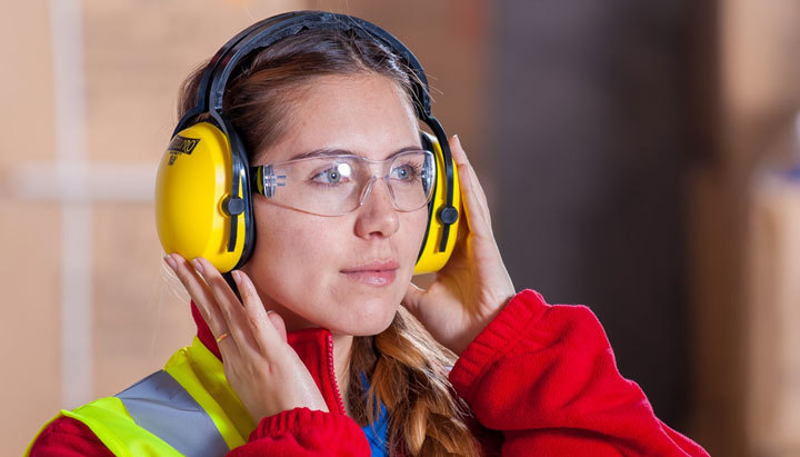female worker wearing ppe headset managed by health & safety software
